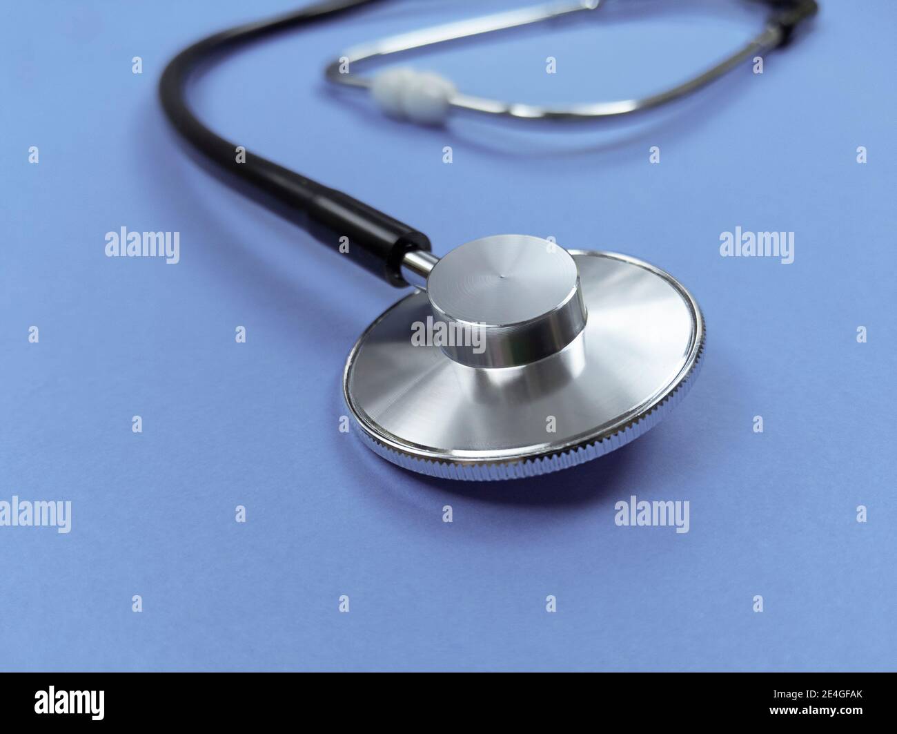 Black stethoscope on a violet background. Stock photo. Stock Photo