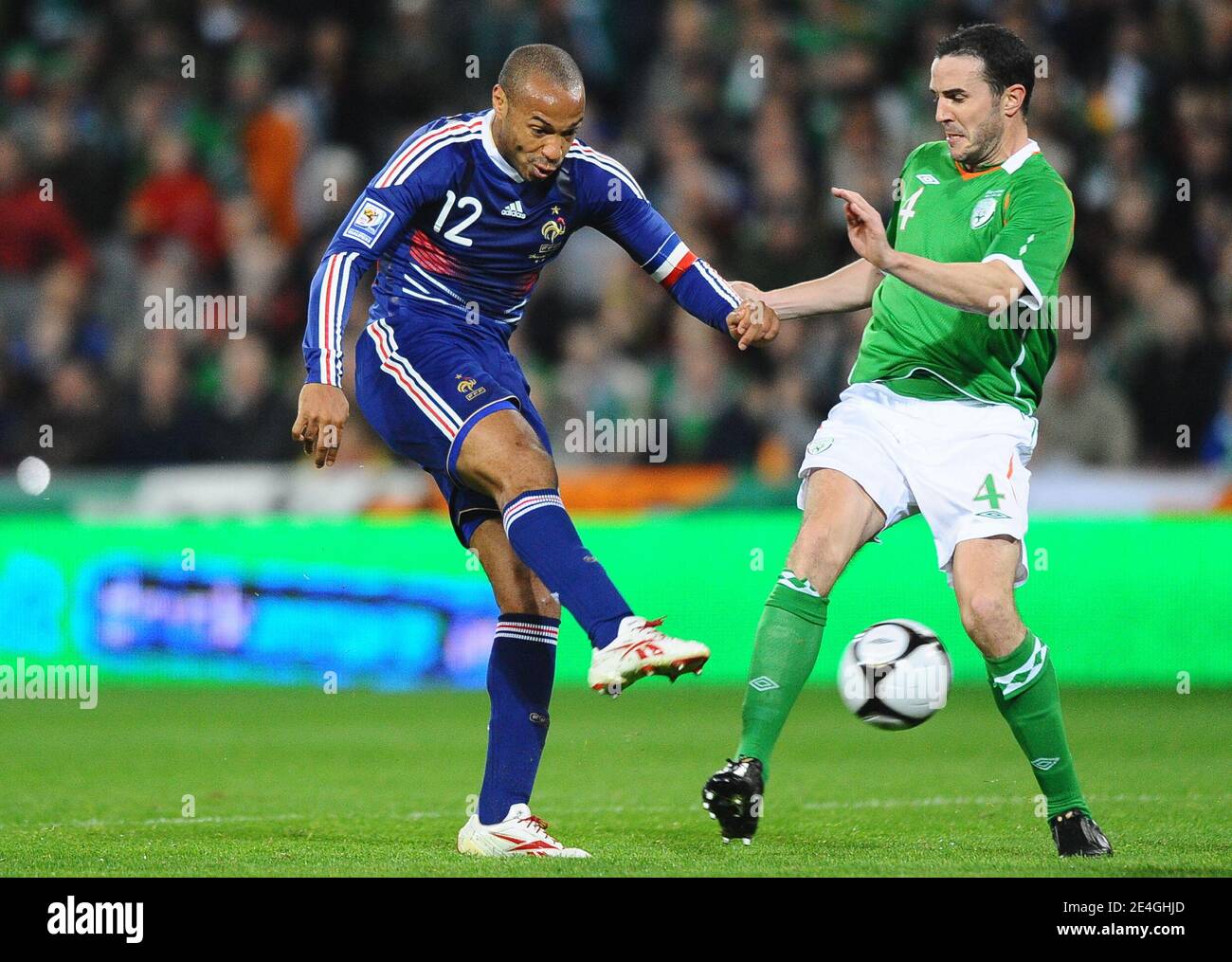 France's Thierry Henry takes a kick in front of Ireland's John O'Shea during the World Cup 2010 Qualifying Play off soccer match, Ireland vs France at Croke Park stadium in Dublin, Ireland on November 14, 2009. France won 1-0. Photo by Steeve McMay/ABACAPRESS.COM Stock Photo