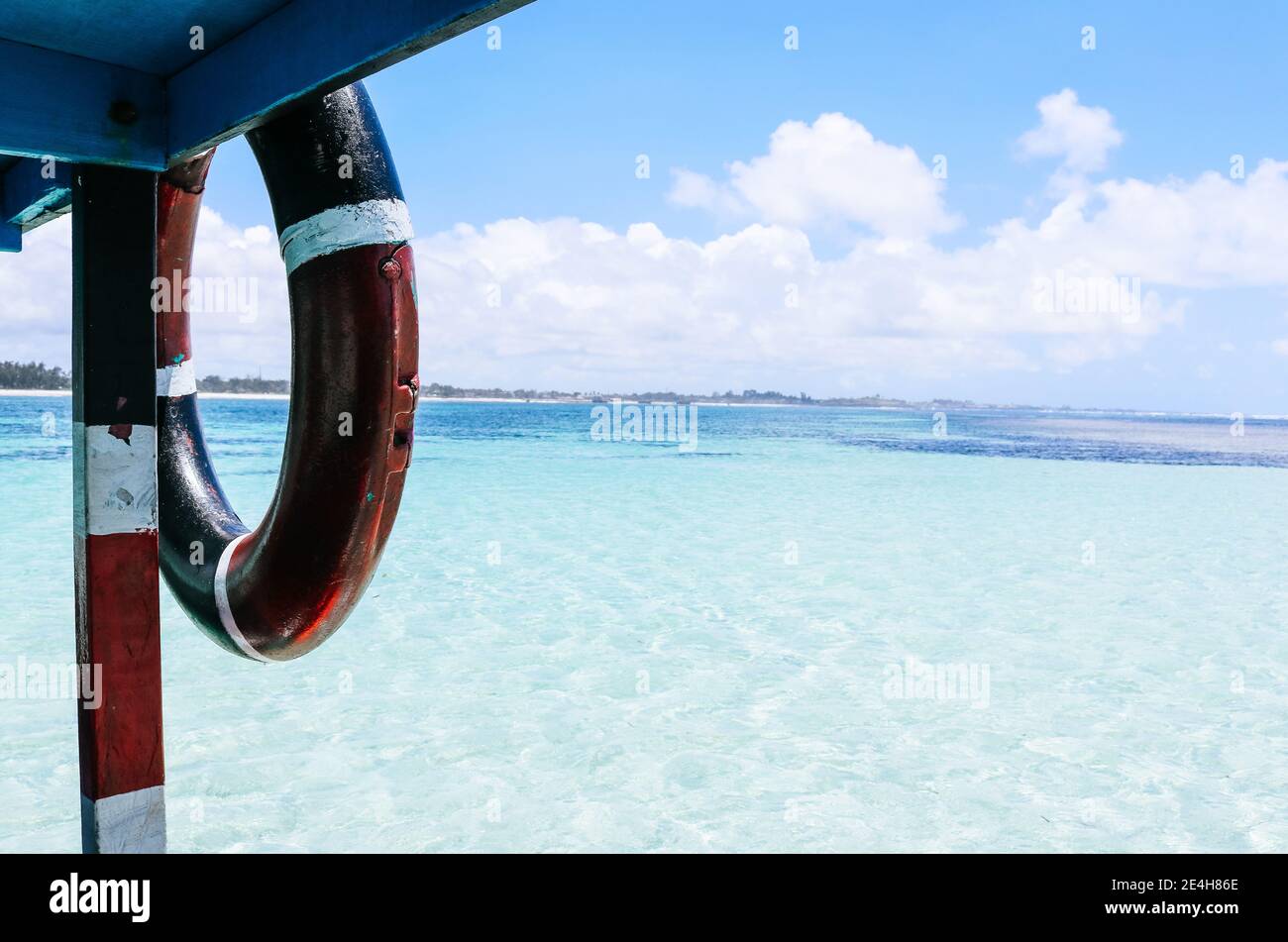 Close up of a Boat with a lifesaver on Crystal clear, turquoise, tropical water Stock Photo