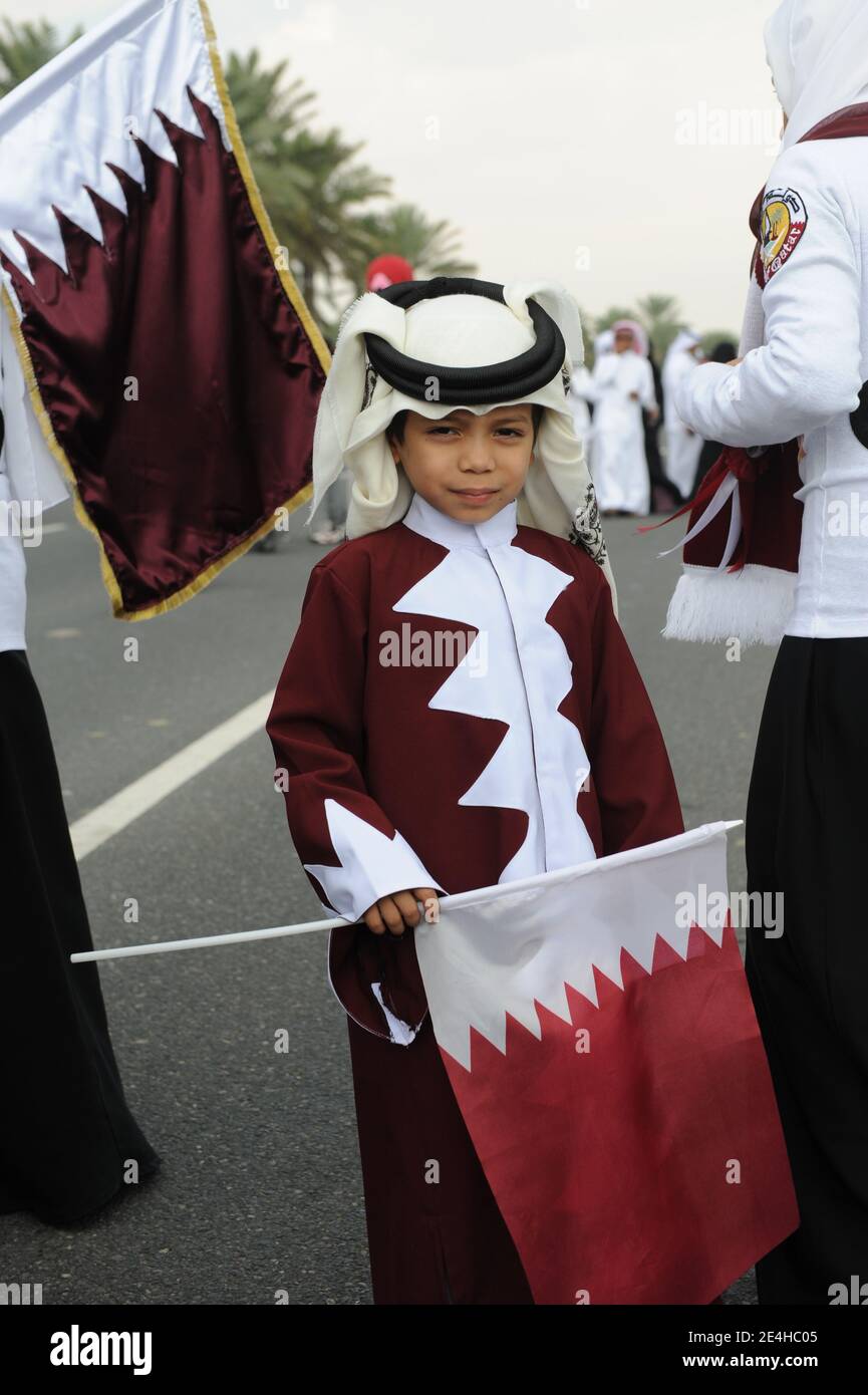 Qatar flag is made as a dress on a young boy as a celebration of Qatar
