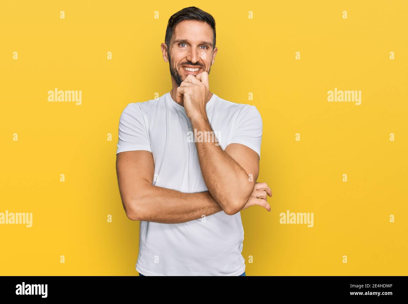 Handsome man with beard wearing casual white t shirt looking confident ...