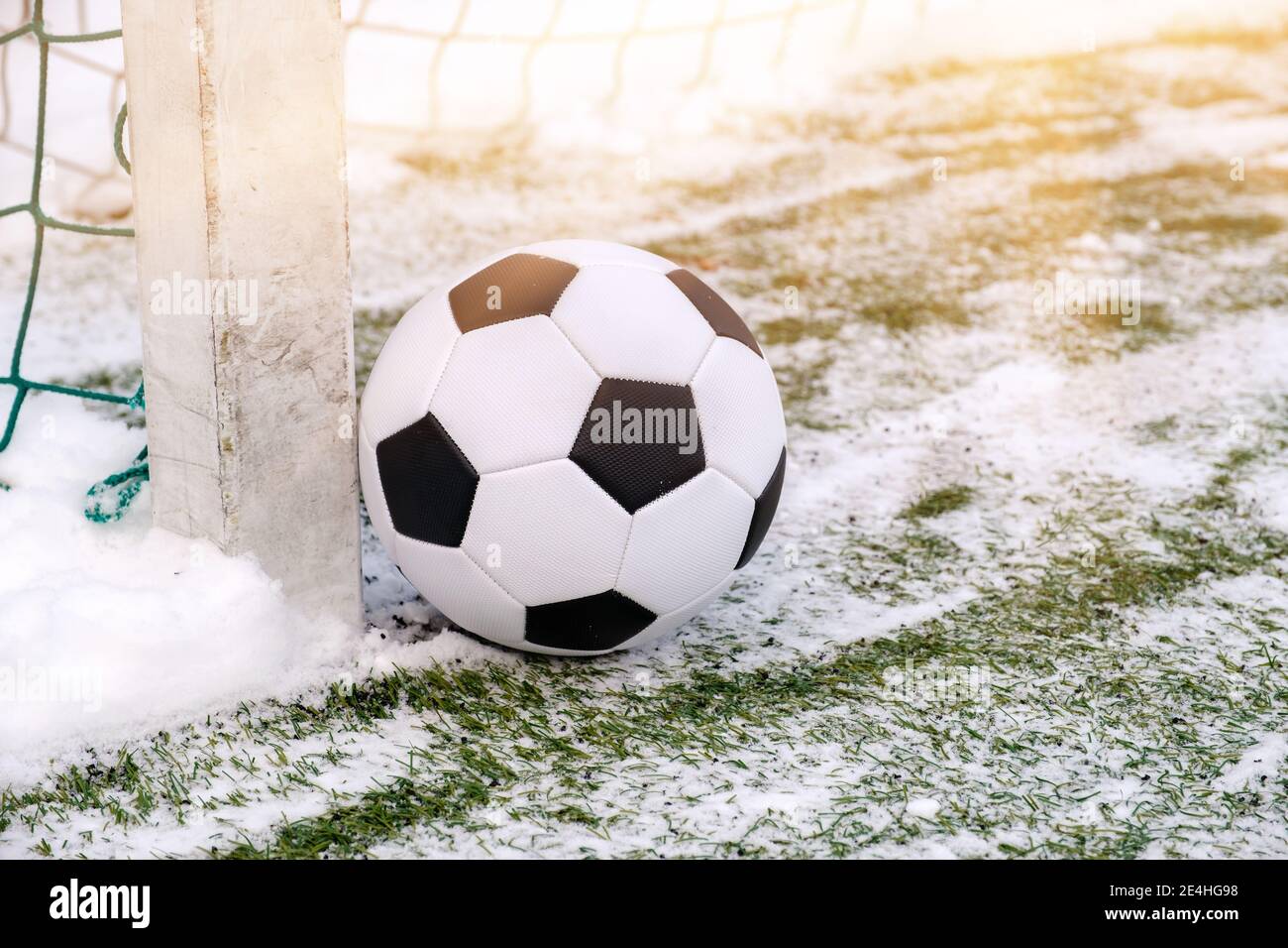 Football ball near soccer goal in winter Stock Photo