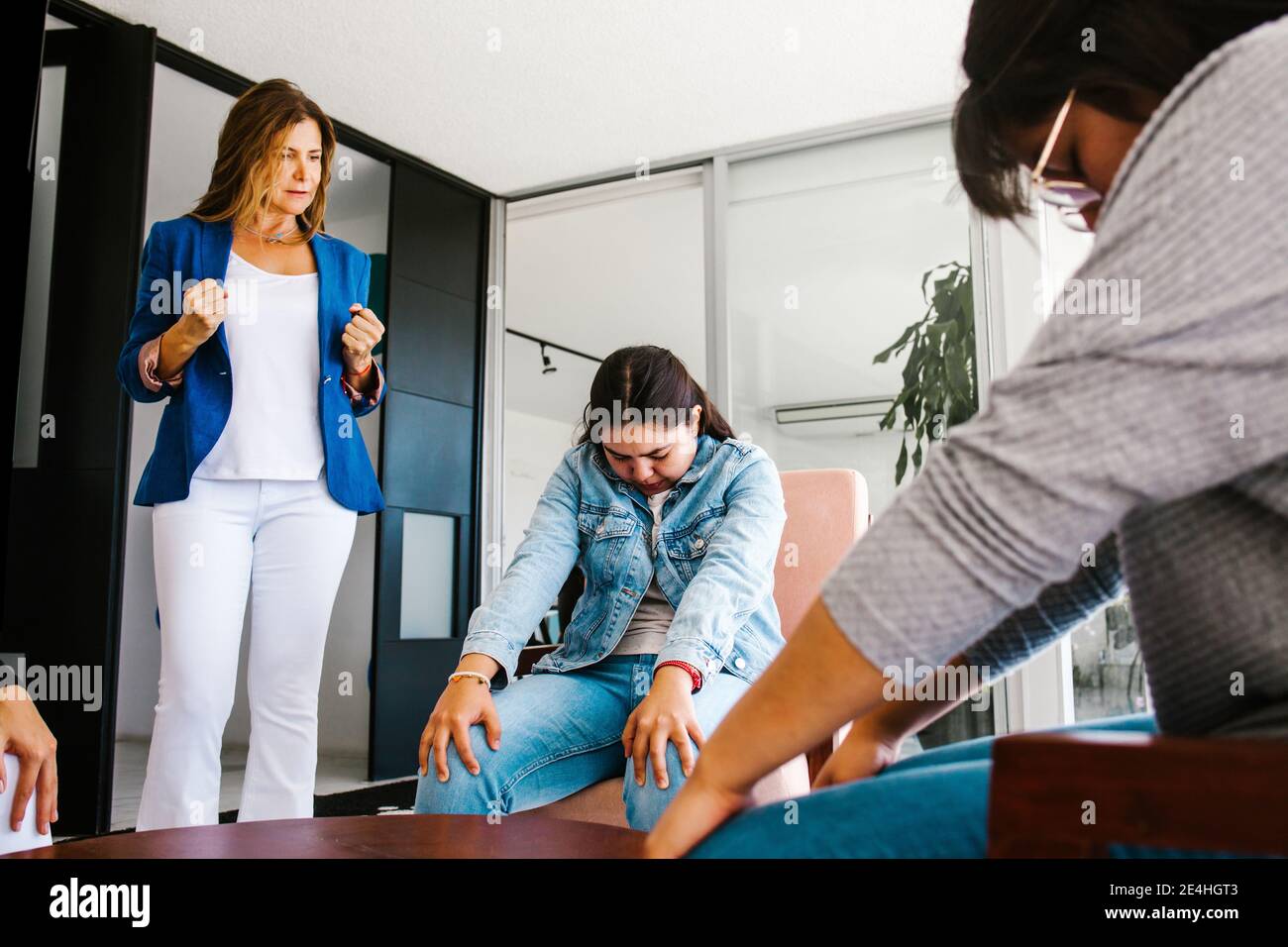 latin business people meditating and doing yoga in office in Mexico city Stock Photo