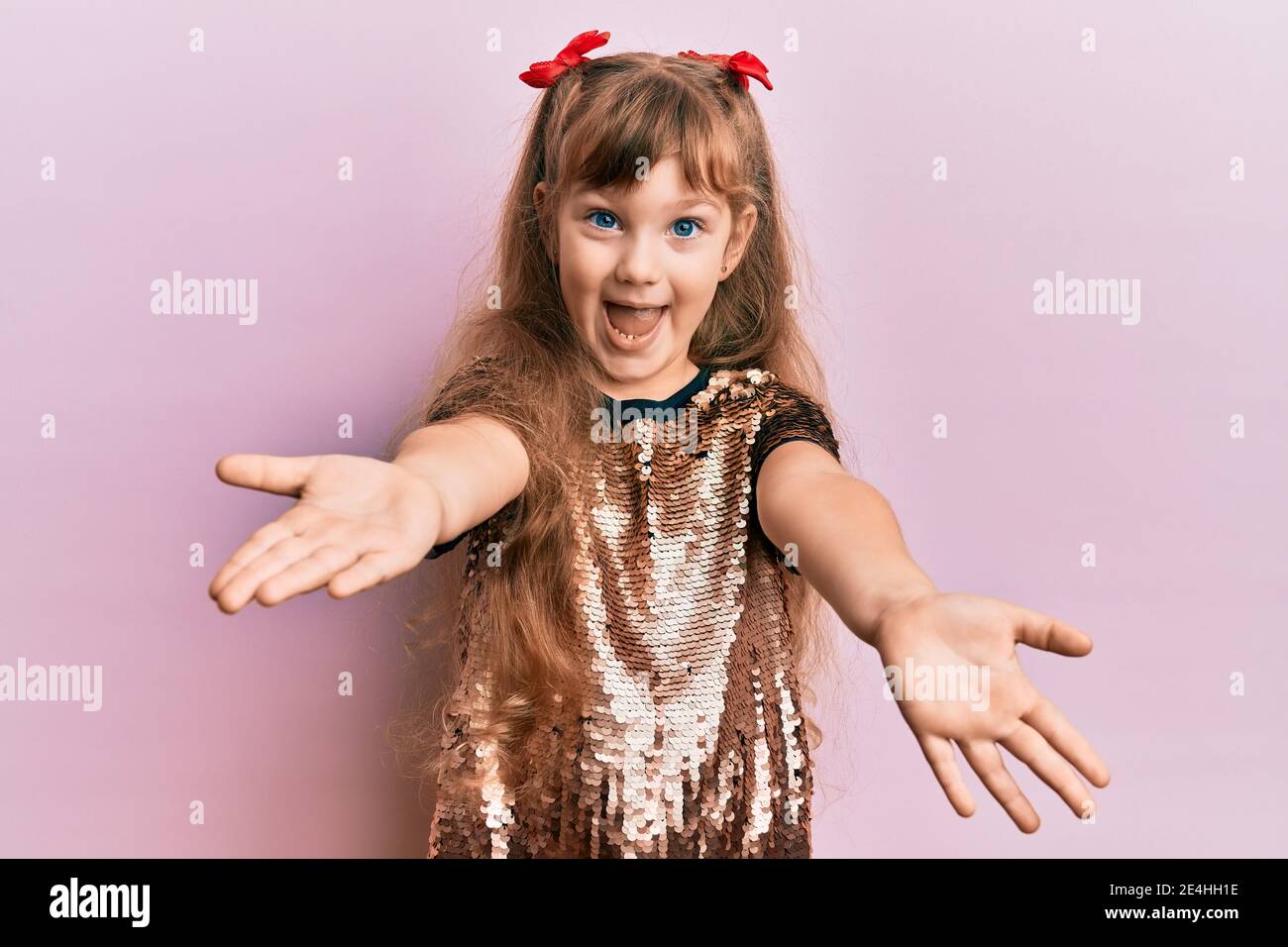 Little caucasian girl kid wearing festive sequins dress looking at the ...