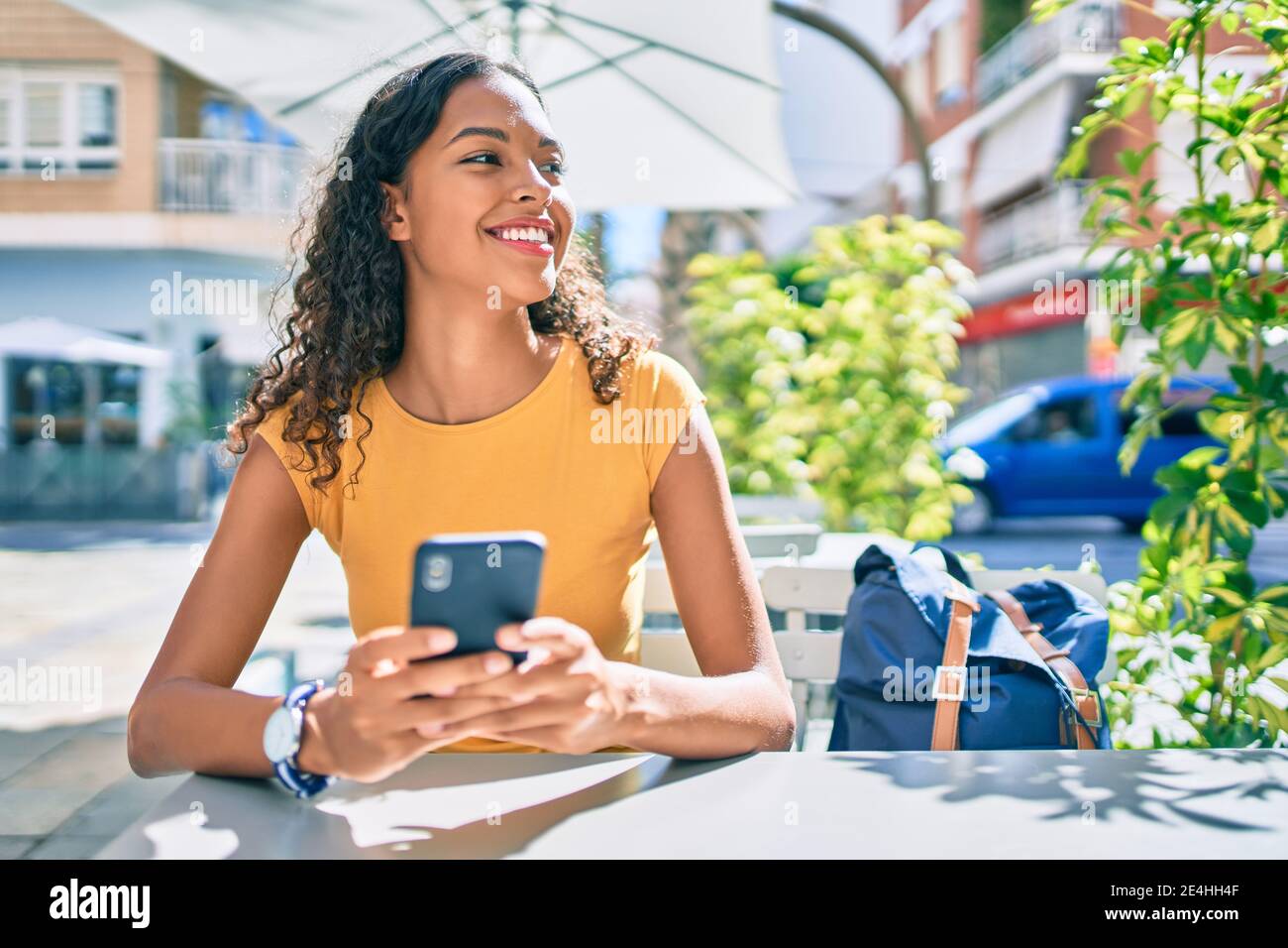 Young african american student girl smiling happy using smartphone ...