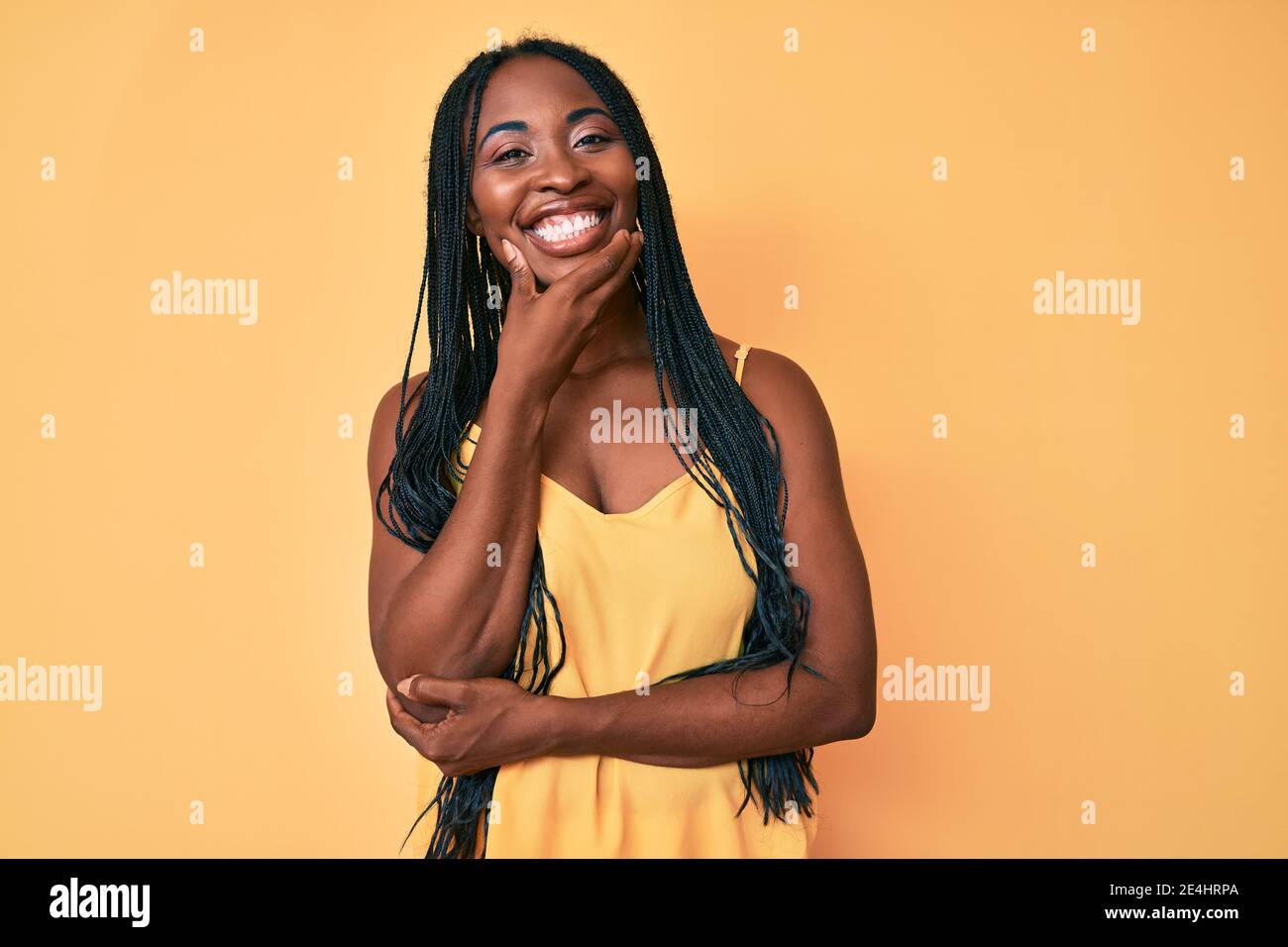 African american woman with braids wearing casual clothes looking ...