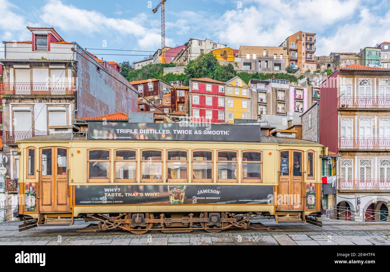 Colorful houses of Porto Ribeira traditional facades old multicolored houses, Dom luis bridge and historic tram. Porto, Portugal . January 2021 Stock Photo
