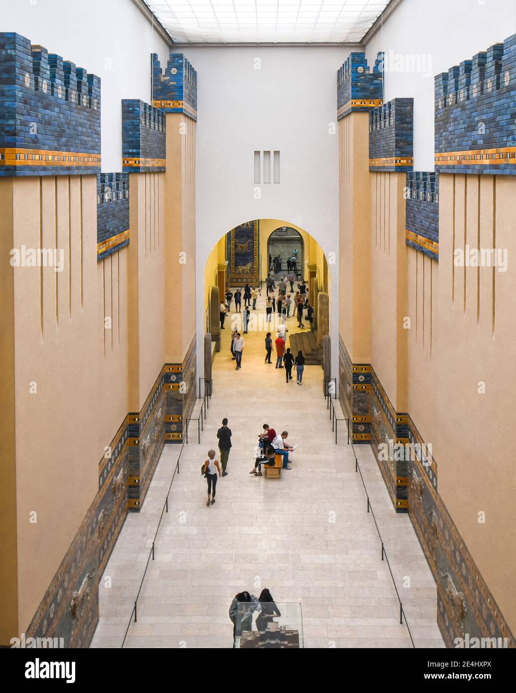 A view from the upper deck as tourists walk past the Processional Way of the ancient Gates of Ishtar exhibit in the Pergamon Museum in Berlin Germany Stock Photo
