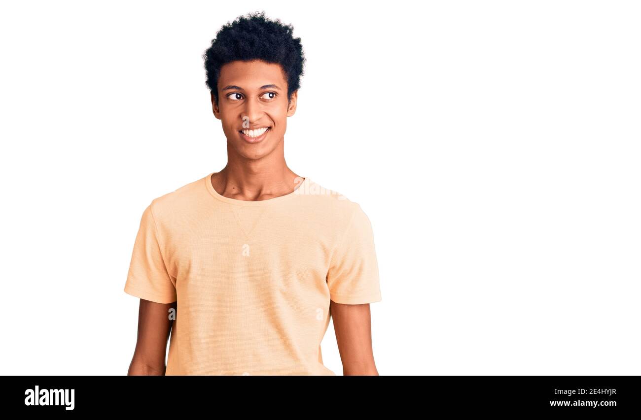 Young african american man wearing casual clothes looking away to side ...