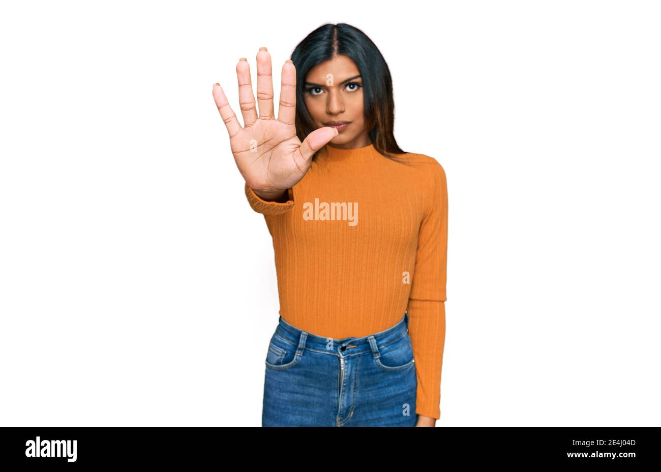 Young latin transsexual transgender woman wearing casual clothes doing stop sing with palm of the hand. warning expression with negative and serious g Stock Photo