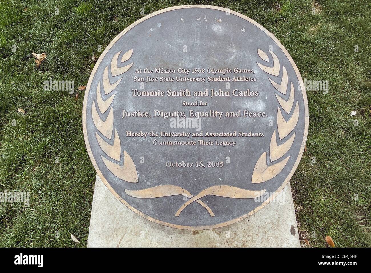 A plaque at the Victory Salute statue at San Jose State University recognizing the black-gloved protest of gold medalist Tommie Smith and bronze medal Stock Photo