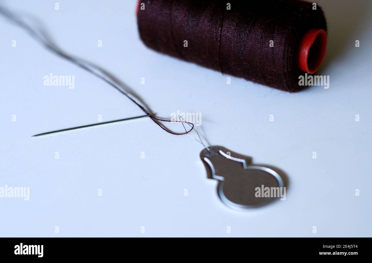Sewing Needle Threader Tool In Use And A Single Black String. Stock Photo,  Picture and Royalty Free Image. Image 198495652.