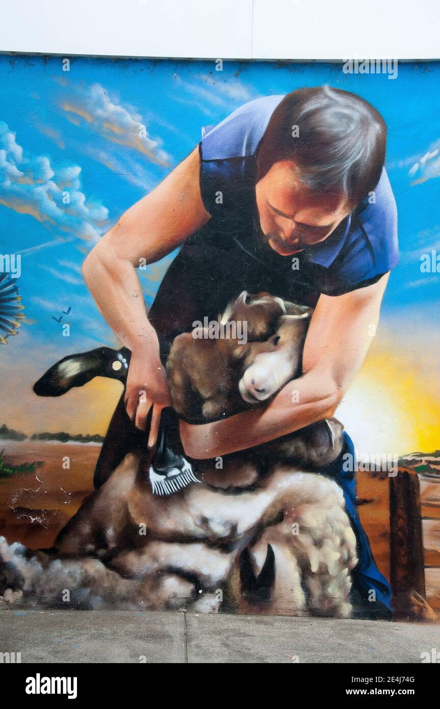 Street art mural by Heesco depicting a sheep farmer and shearer with his dog, at Yarram, South Gippsland, Victoria Stock Photo