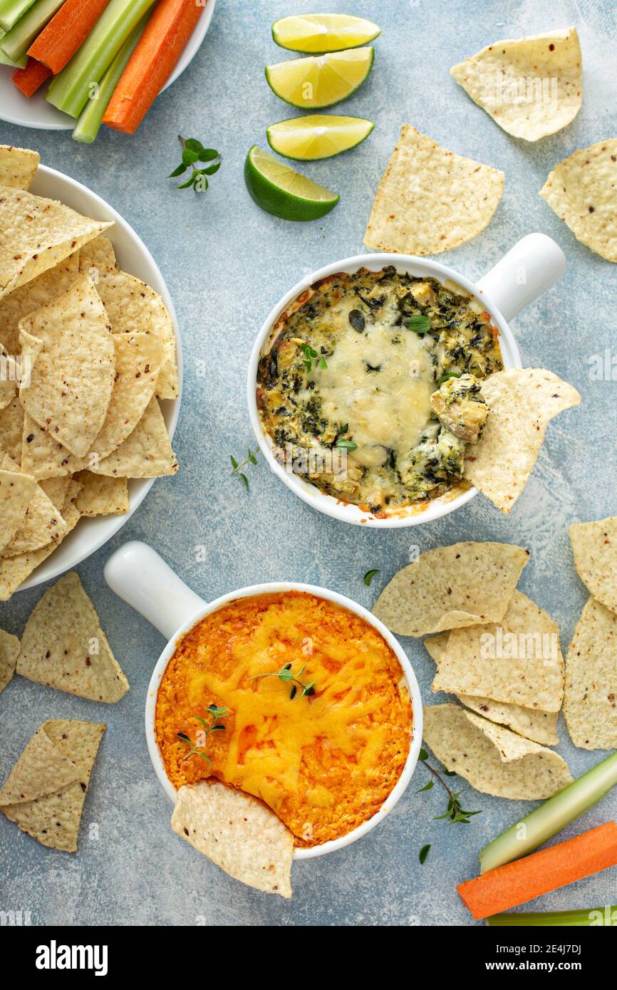 Artichoke spinach and buffalo chicken dips with chips Stock Photo Alamy