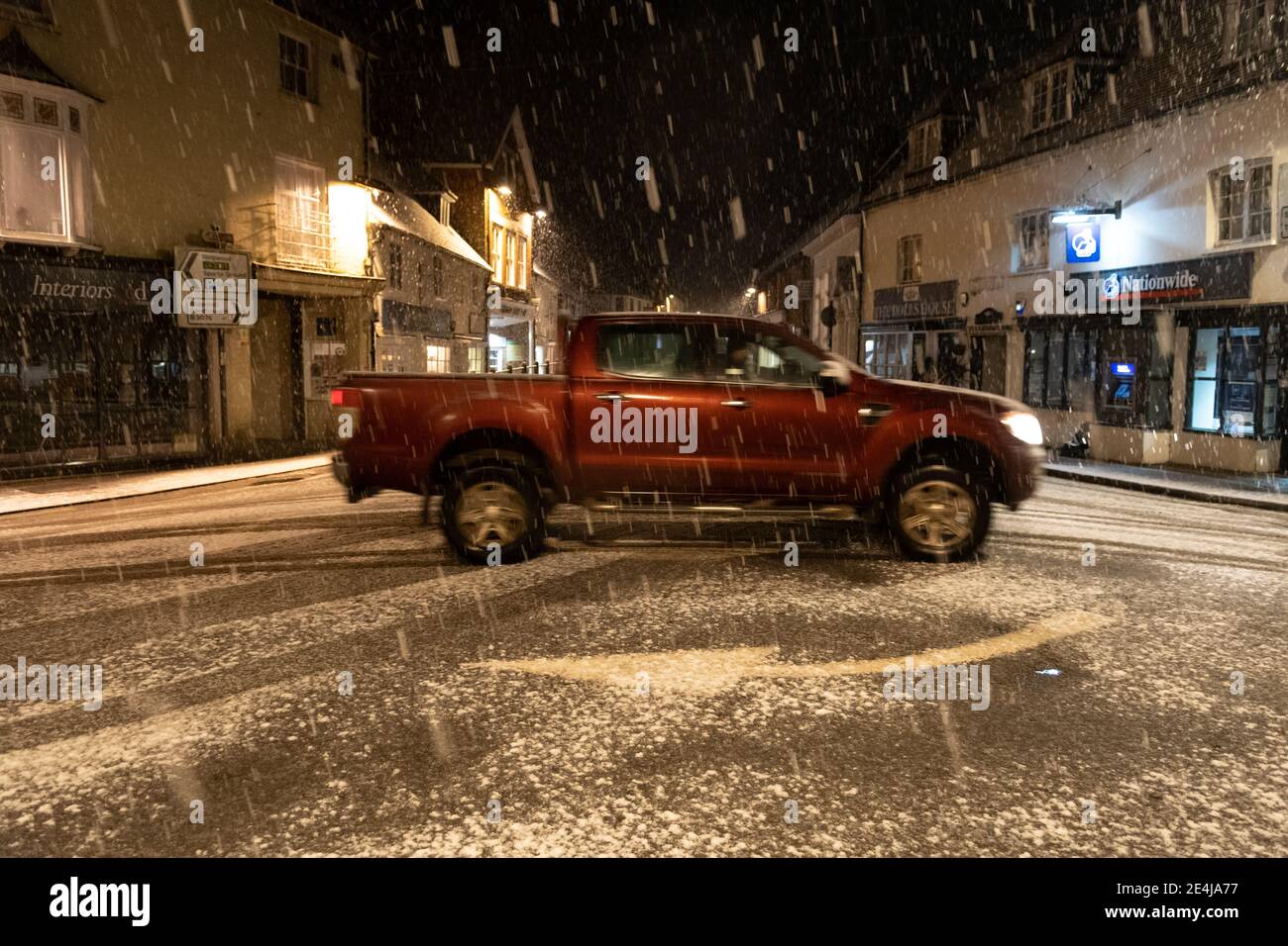 Fordingbridge, New Forest, Hampshire, UK, Sunday 24th January, 2021, Weather: Snow arrives before dawn in the New Forest market town. Several cm could accumulate through the day, the first snow of the winter for the region. Credit: Paul Biggins/Alamy Live News Stock Photo