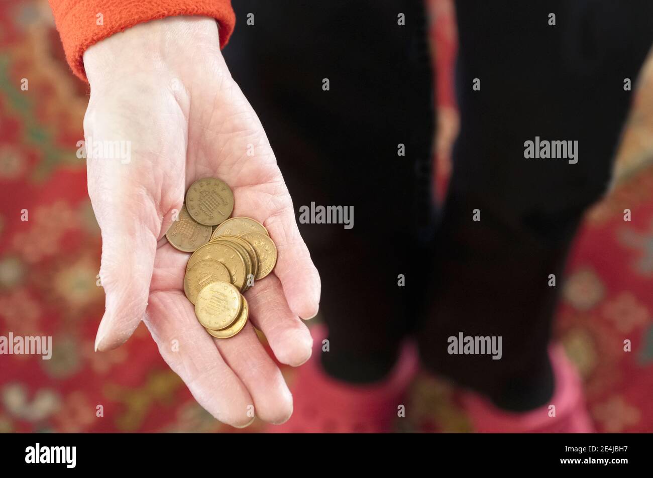 Poor society elderly senior hand of senior person full of worthless copper coins Stock Photo