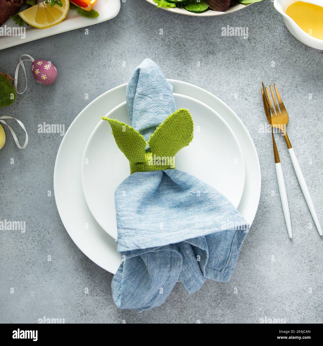 Easter brunch table setting with a napkin on a plate Stock Photo