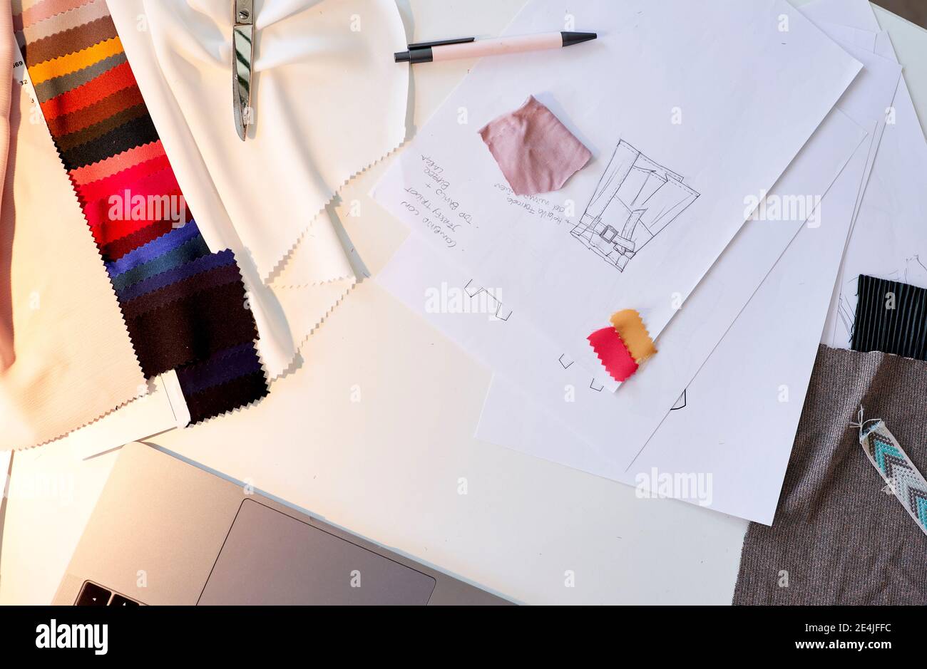 Design on paper with fabric swatches at desk in atelier Stock Photo - Alamy