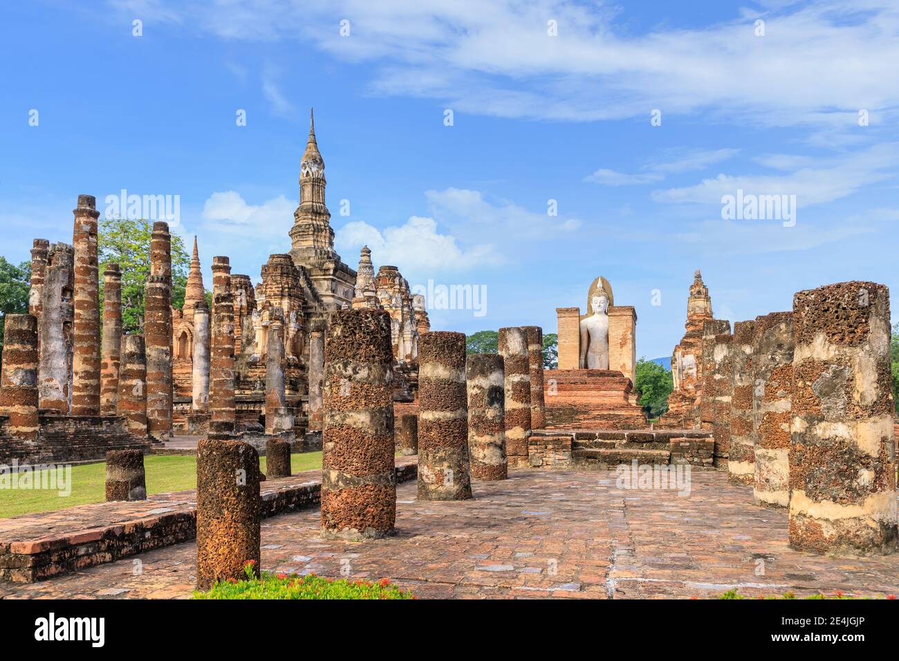 Standing Buddha statue in ruined chapel in monastery complex at Wat Mahathat temple, Sukhothai Historical Park, Thailand Stock Photo