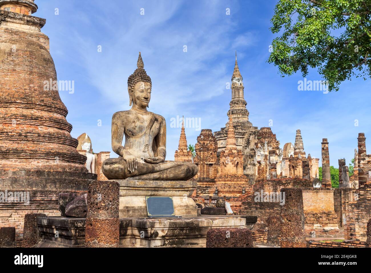 Buddha statue and pagoda Wat Mahathat temple, Sukhothai Historical Park, Thailand Stock Photo