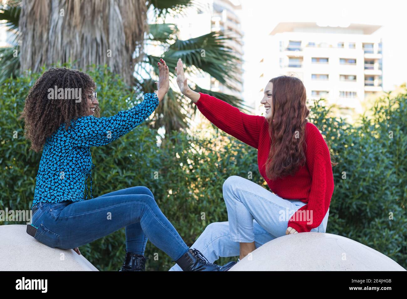 Two young women giving high five hi-res stock photography and images ...