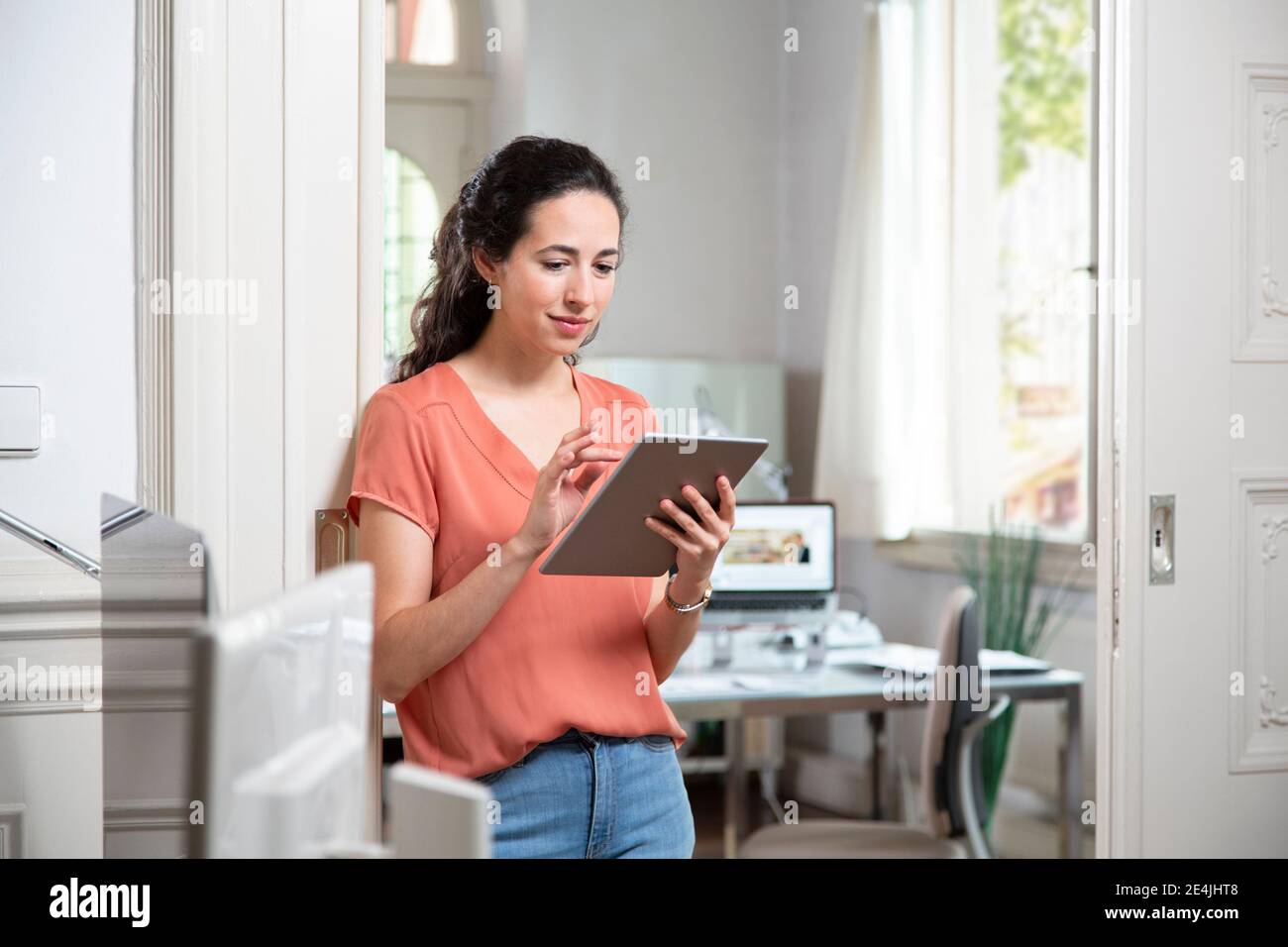 Female professional using digital tablet while standing in office Stock ...