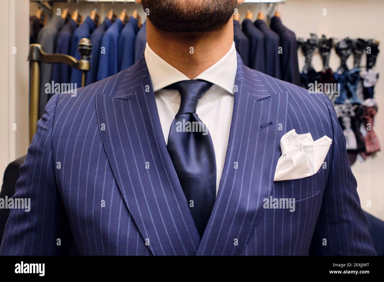 Man in blue pinstripe suit in tailors boutique Stock Photo