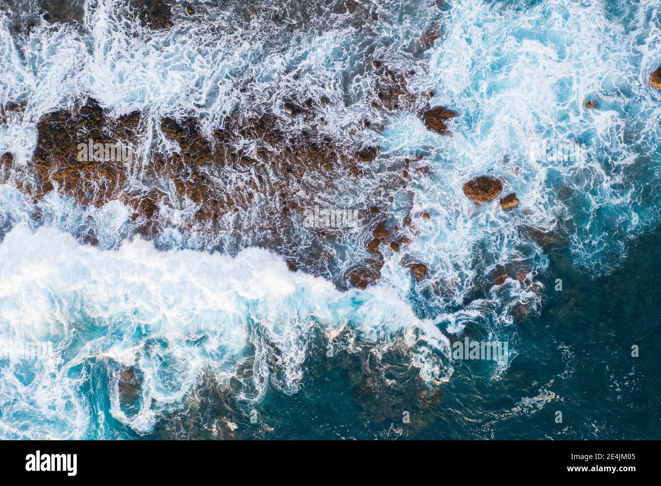 Surf on rocky coast from above, Valle Gran Rey, drone shot, La Gomera, Canary Islands, Spain Stock Photo