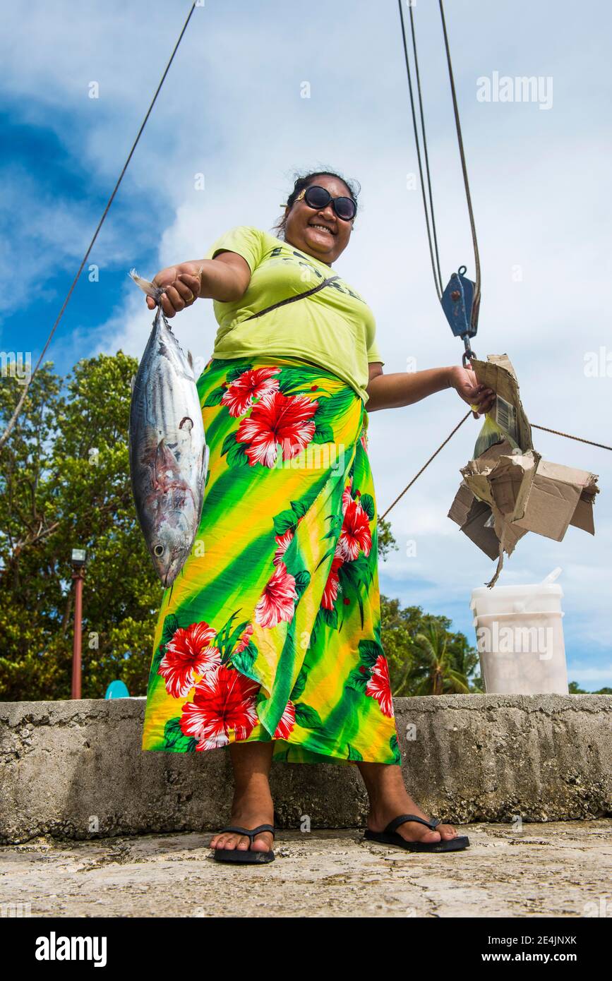 Local woman presenting fresh tuna fish, Tuvalu Stock Photo