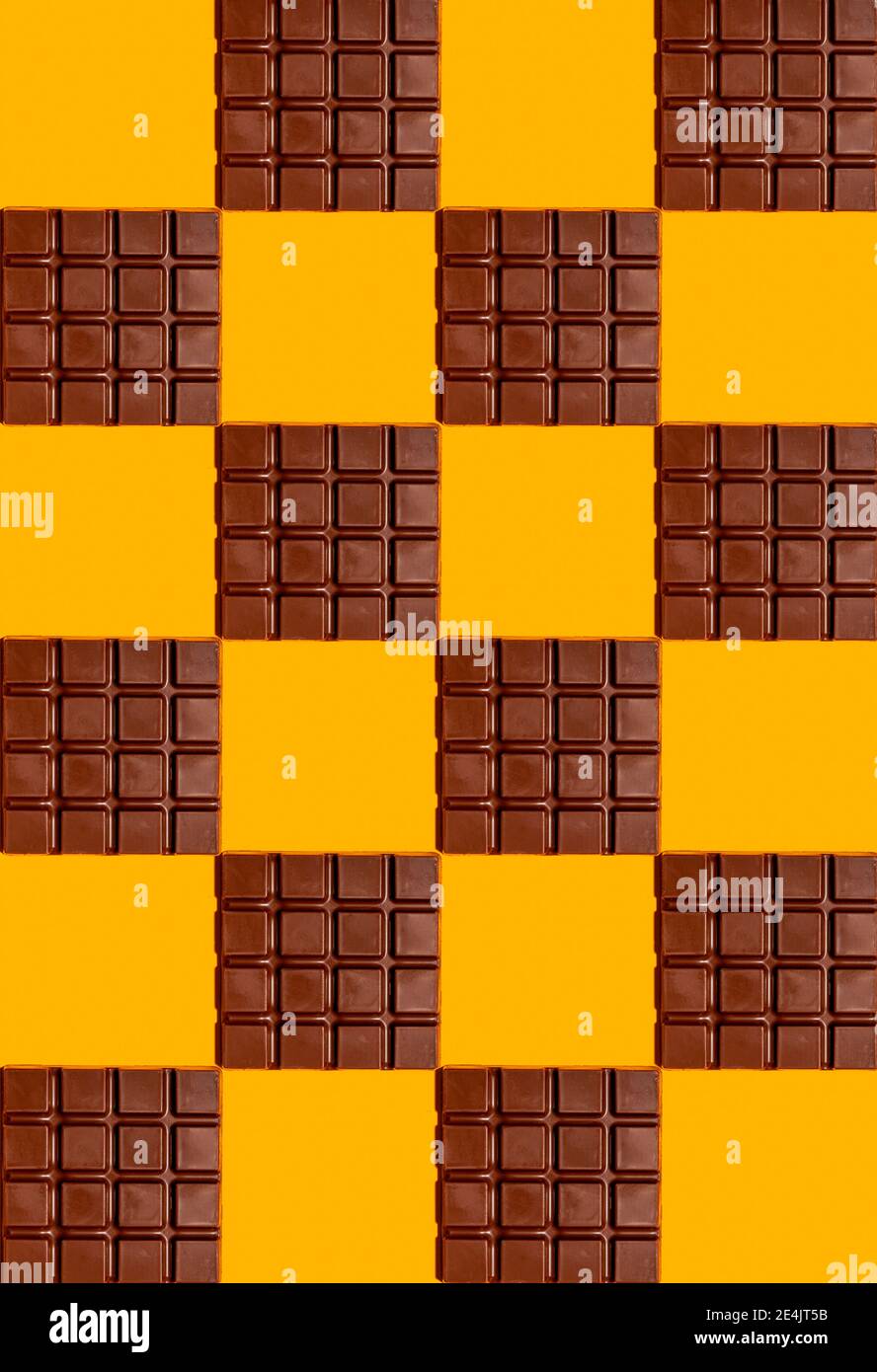 Pattern of chocolate bars against yellow background Stock Photo - Alamy