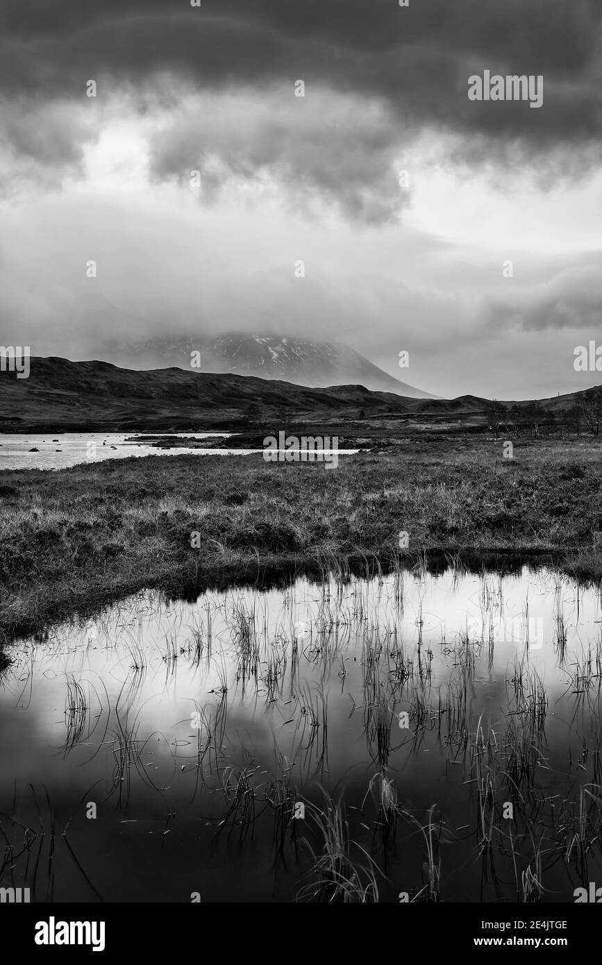 Epic  black and white landscape image of Loch Ba on Rannoch Moor in Scottish Highlands on a Winter morning Stock Photo