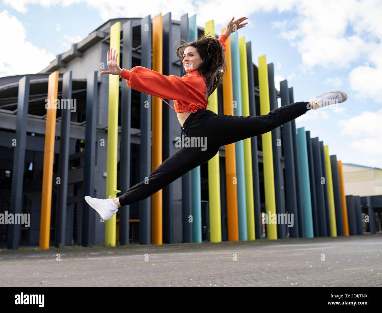 Portrait happy young woman jumping building hi-res stock photography ...