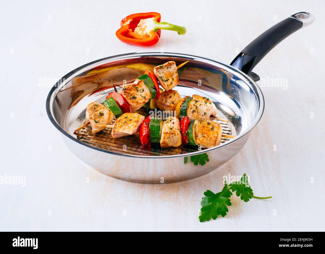 Fried chicken skewers with vegetables on frying pan Stock Photo Alamy