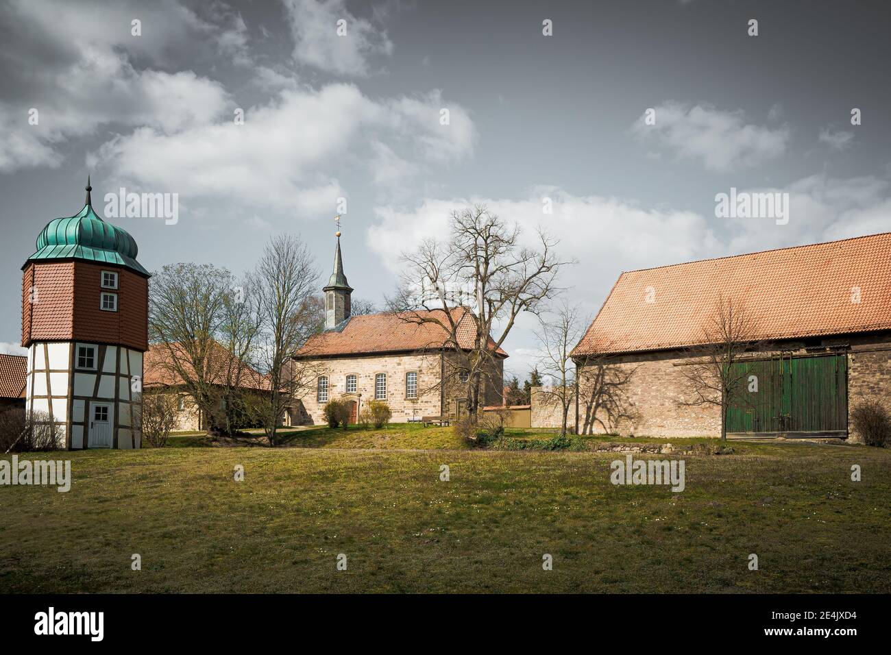 An old monastery courtyard with a bank and a small chapel, outdoor shot. Stock Photo