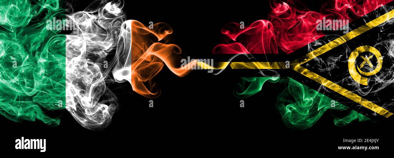 Republic of Ireland, Irish vs Vanuatu smoky mystic flags placed side by side. Thick colored silky abstract smoke flags. Stock Photo