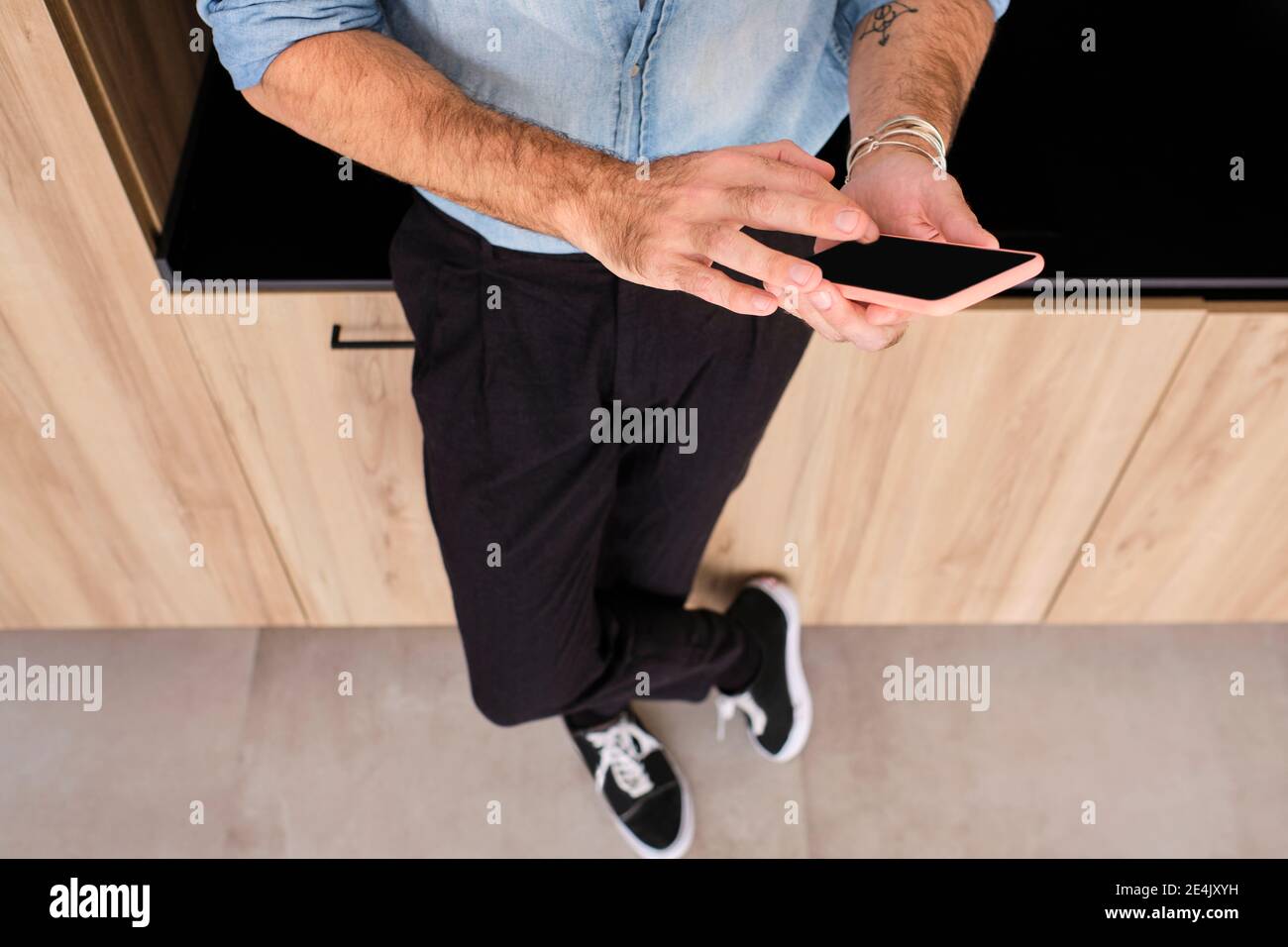 Mature man using smart phone at home Stock Photo