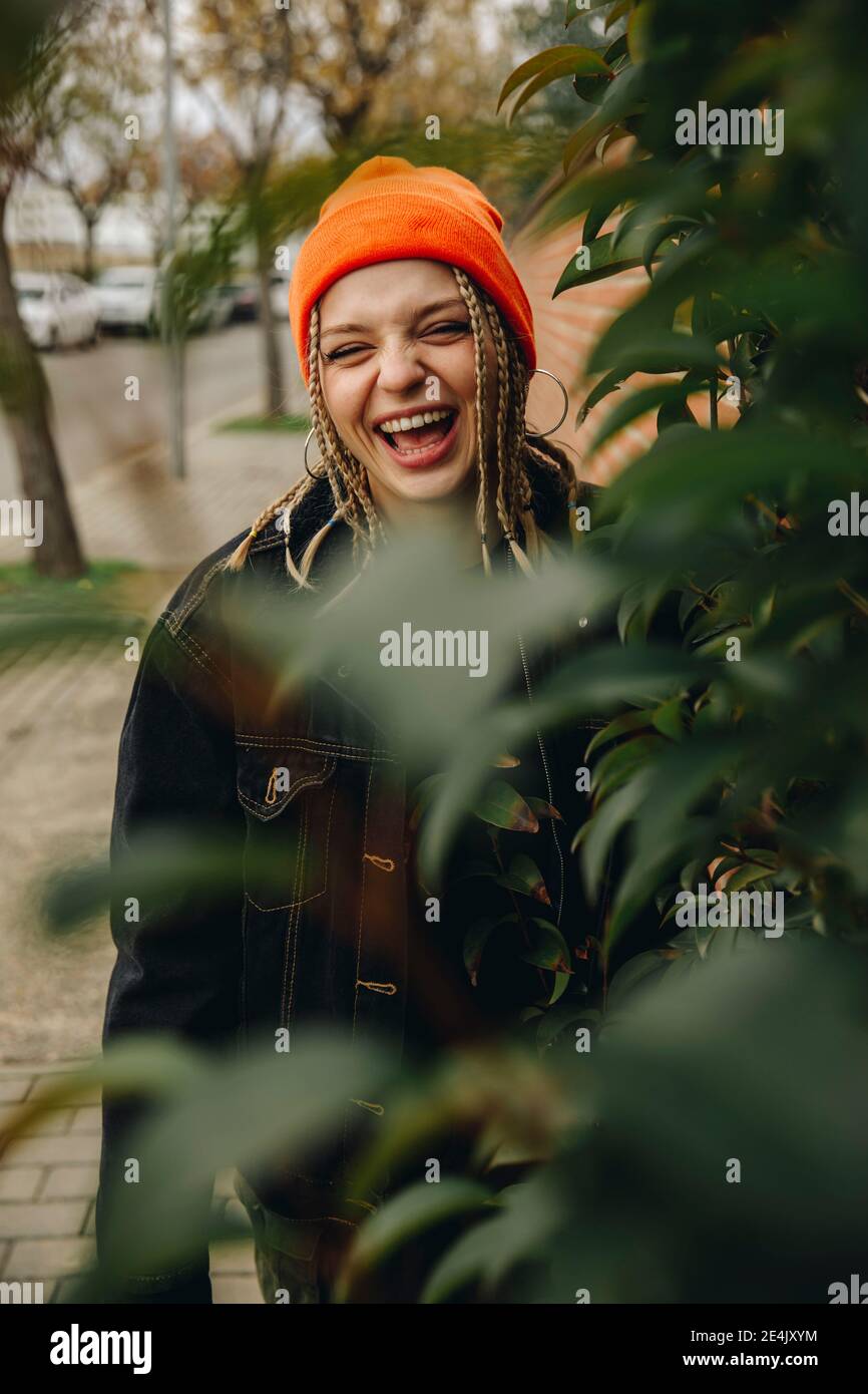 Cheerful woman in orange hat hi-res stock photography and images - Alamy