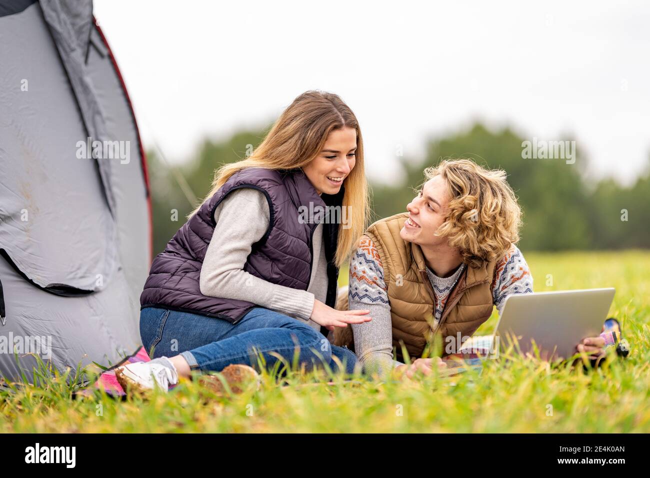 Brother and sister lying together on grass with digital tablet Stock ...