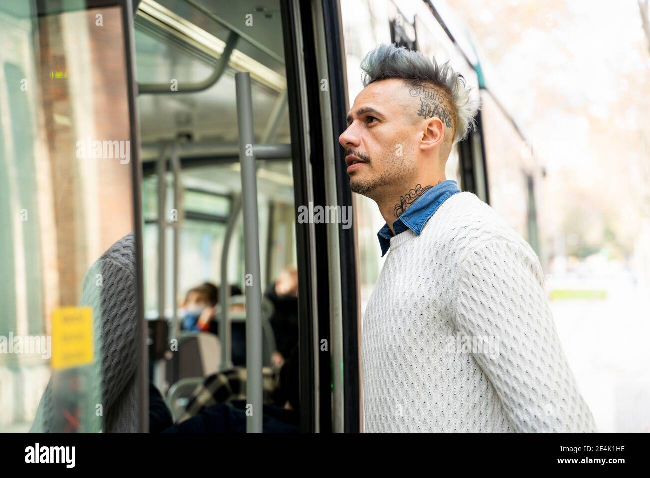 Stylish male entrepreneur commuting in train Stock Photo