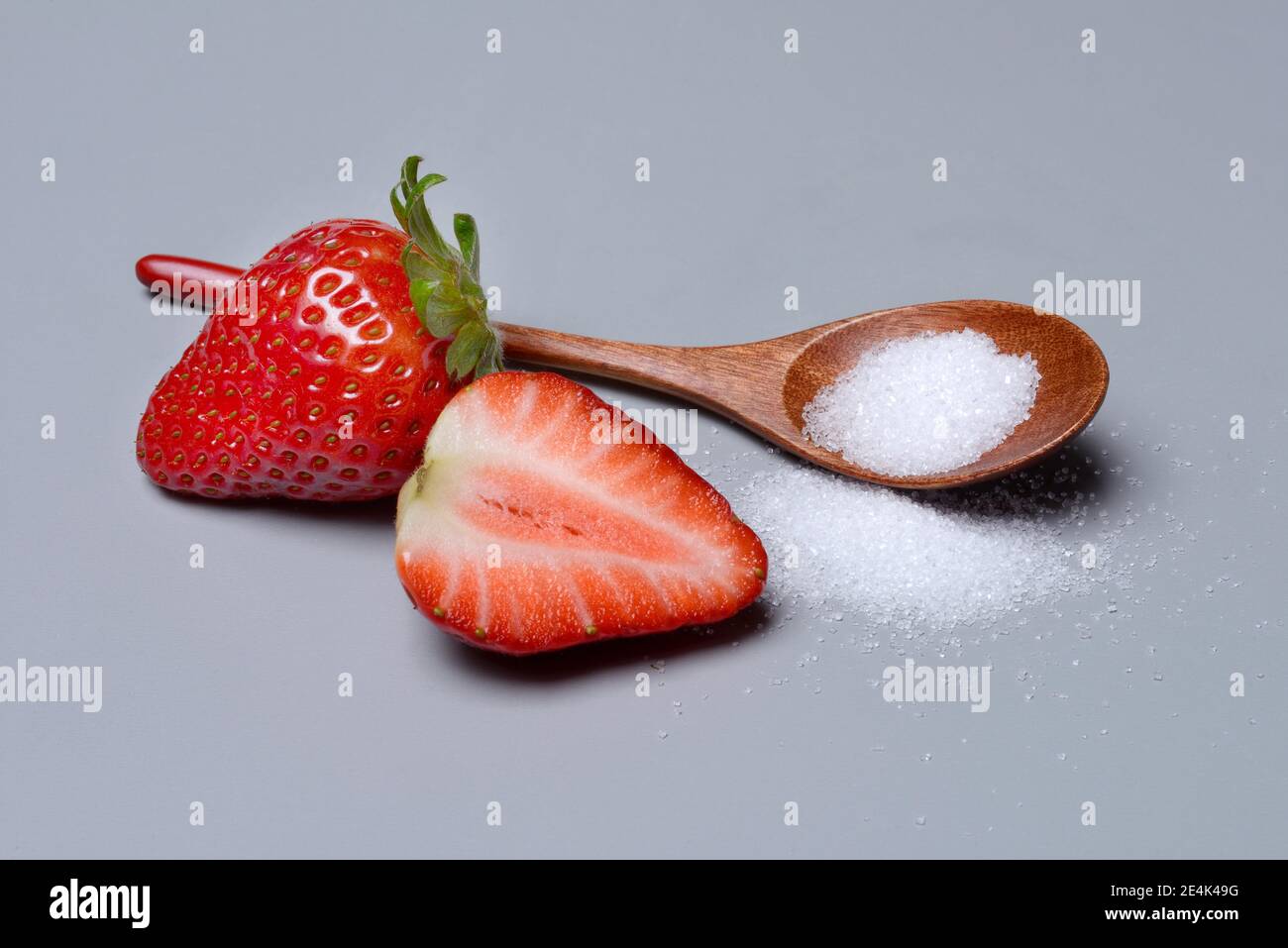 Strawberries and sugar with spoon, sugar consumption, white sugar Stock
