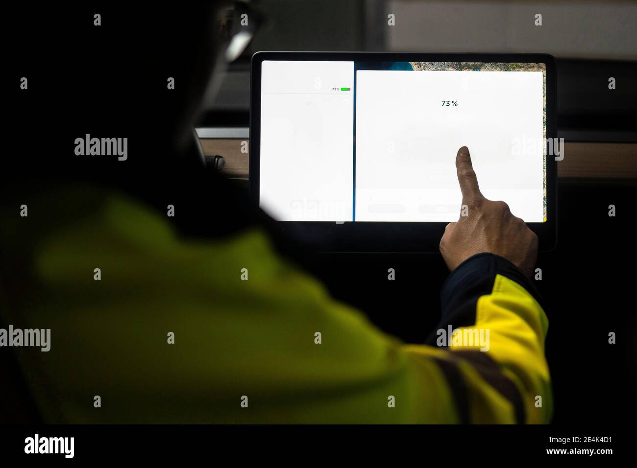 Mature technician using digital tablet for programming in car Stock Photo