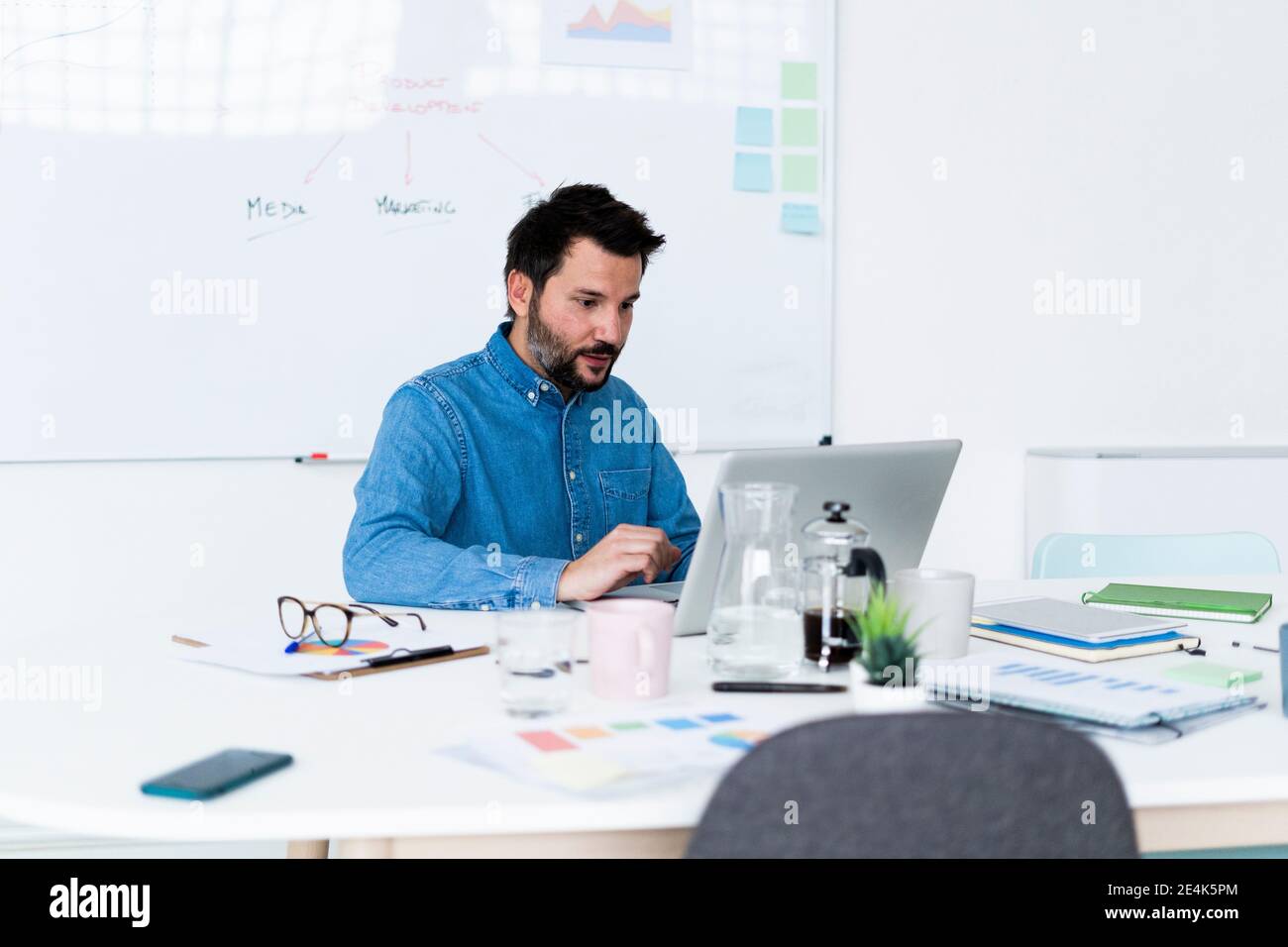 Man using laptop in office Stock Photo