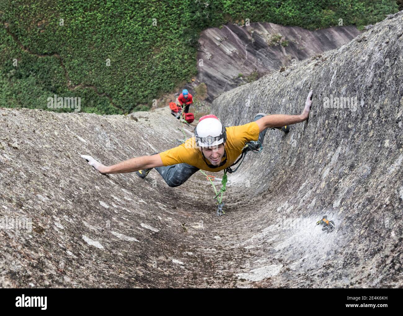 Male rock climber challenging steep wall of Pedra Baiana Stock Photo