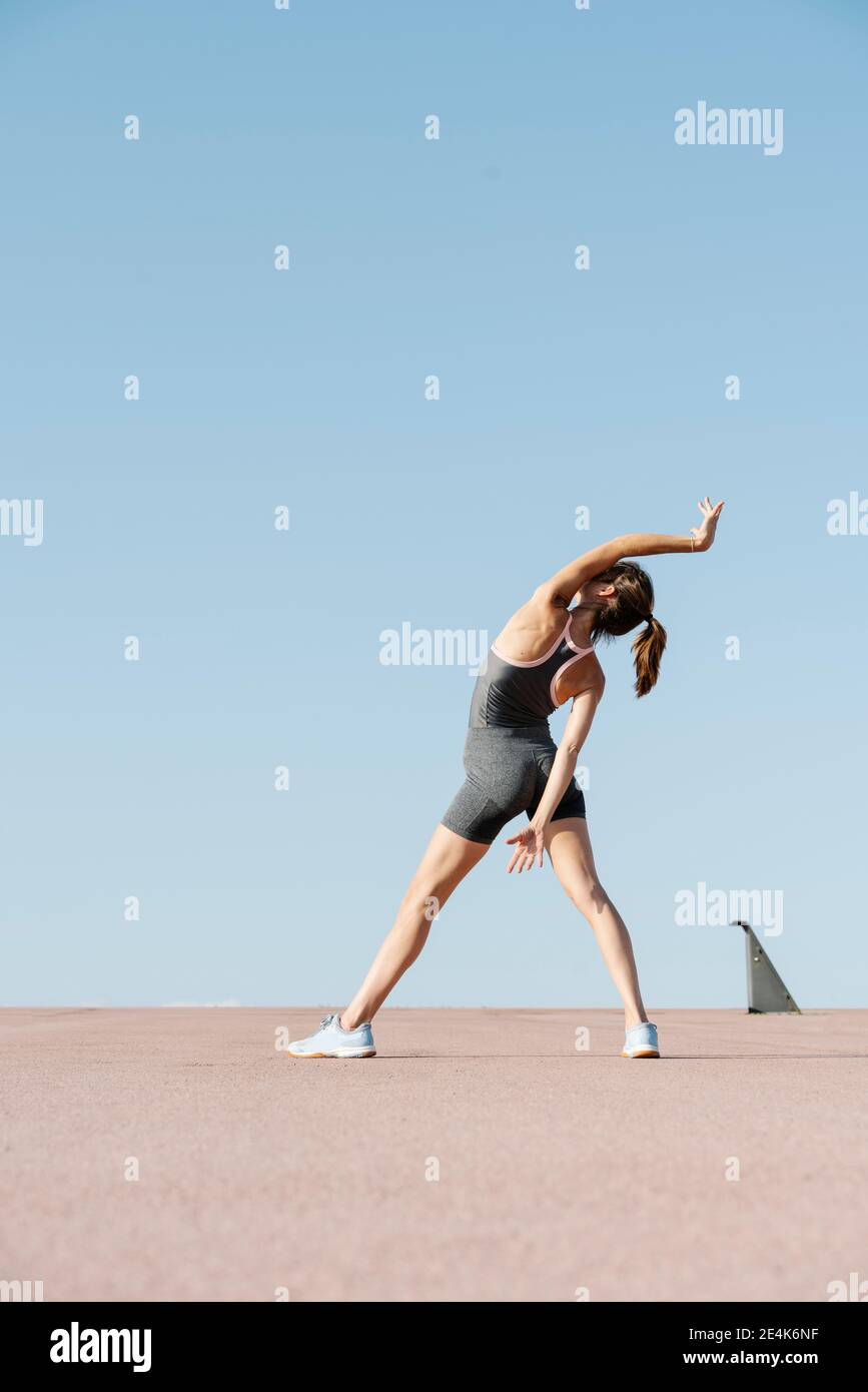 Elegant sportswoman practicing yoga on a sunny day Stock Photo