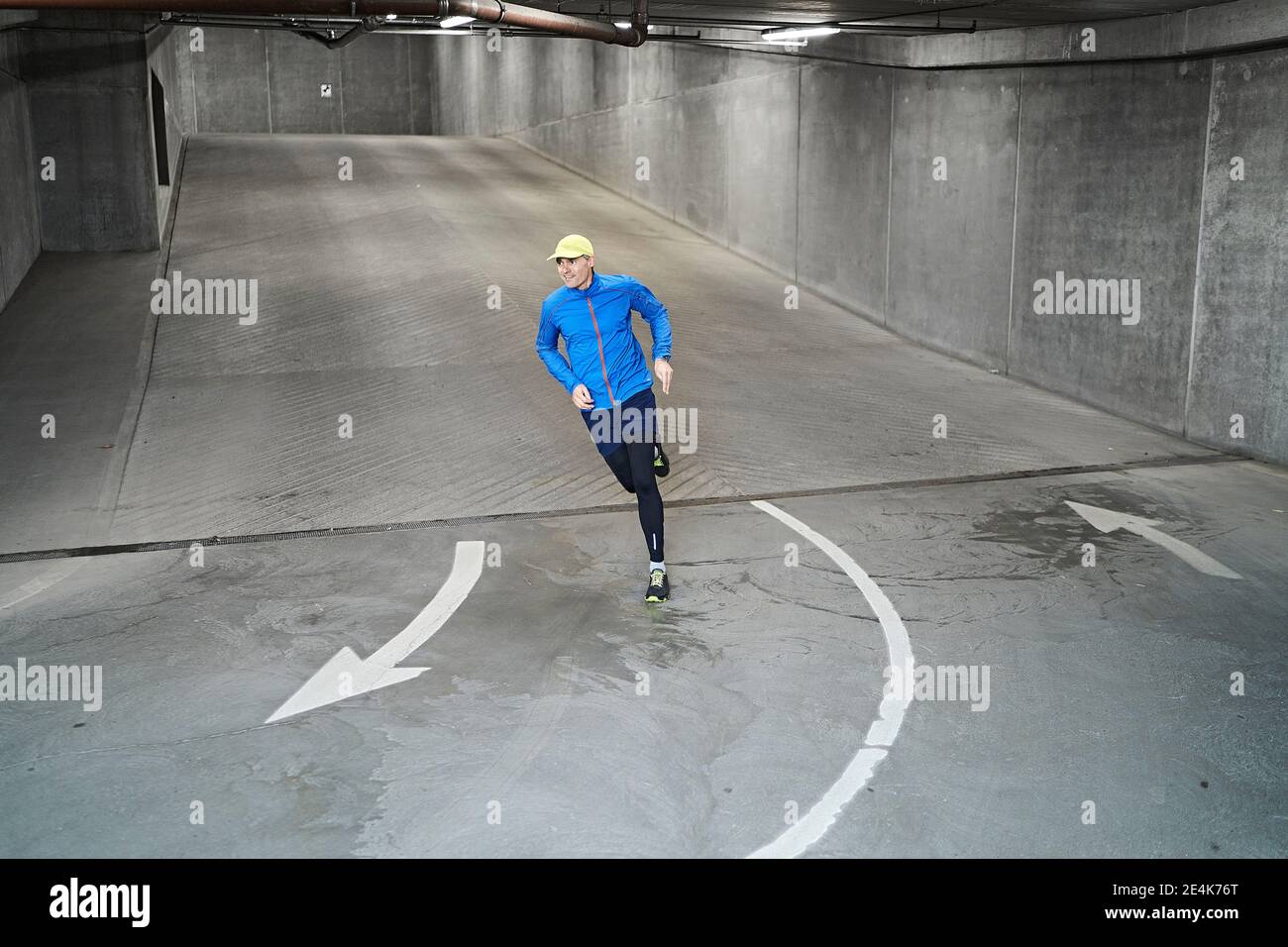 Mature man running in parking garage of residential building Stock Photo