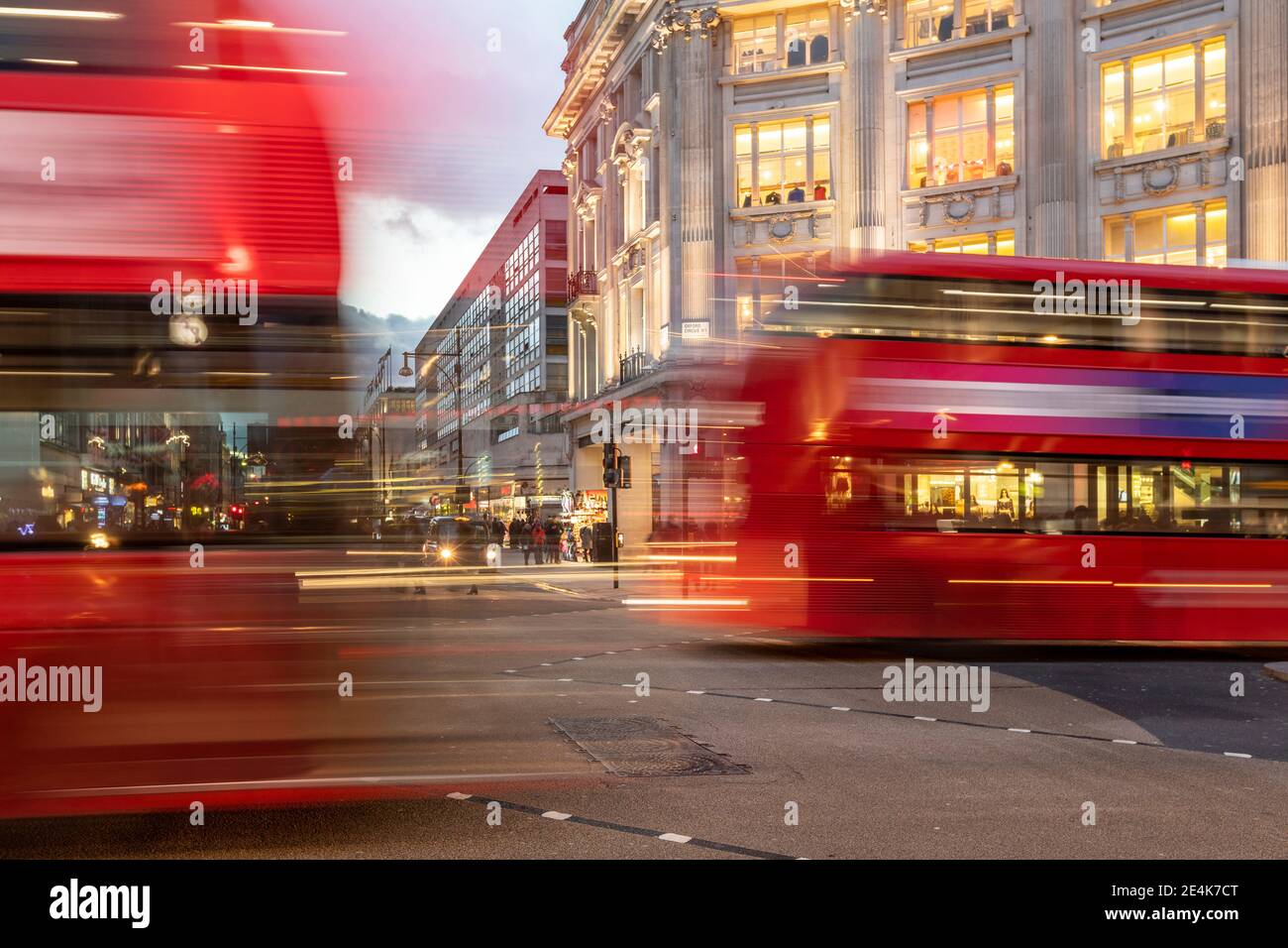 UK, London, Red double decker bus crossing Oxford Circus junction at dusk, blurred Stock Photo