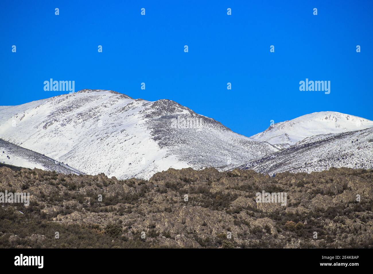 Snowy Mountain Landscape With Rocks Foreground With Blue White And Green Tones Stock Photo Alamy