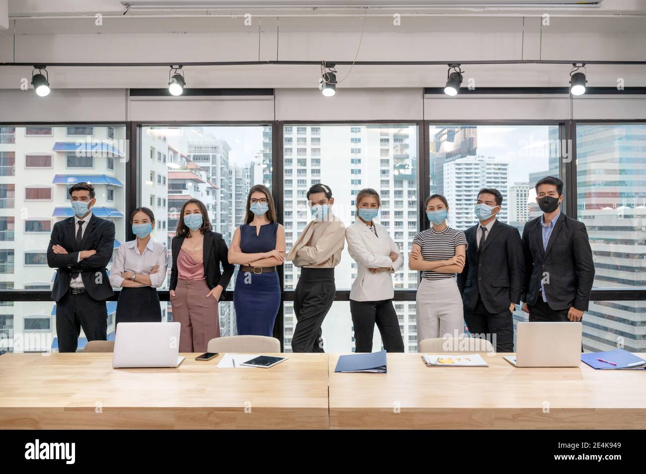 Multiethnic business team confident wearing face mask standing in ...