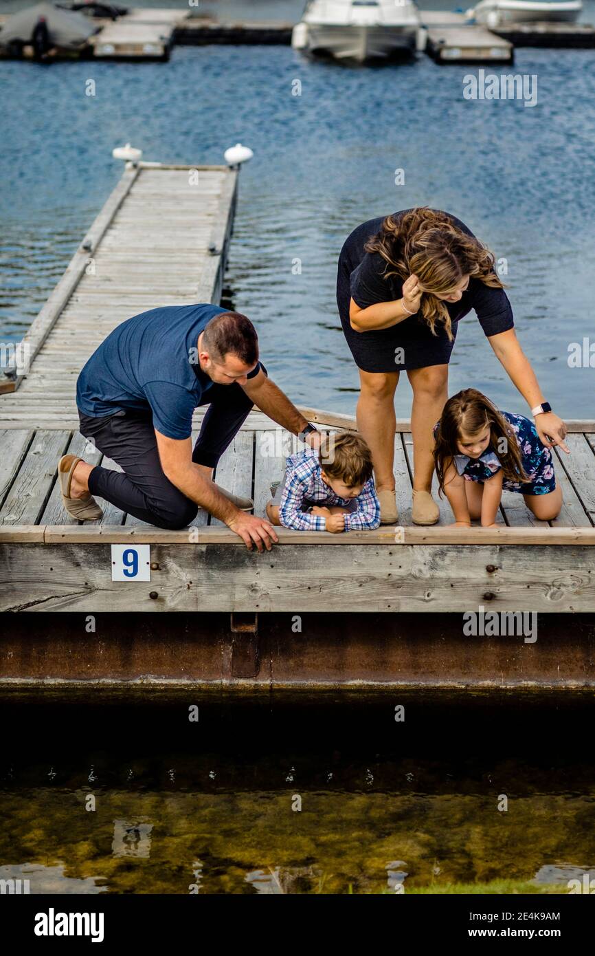 Family looking at water from pier Stock Photo