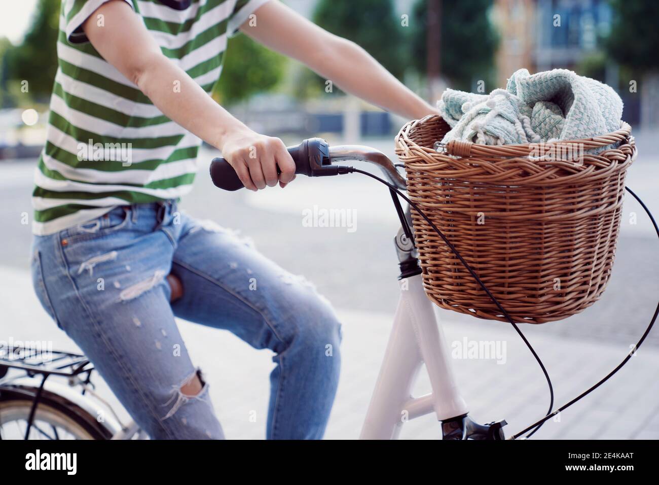 Woman cycling in city during weekend Stock Photo